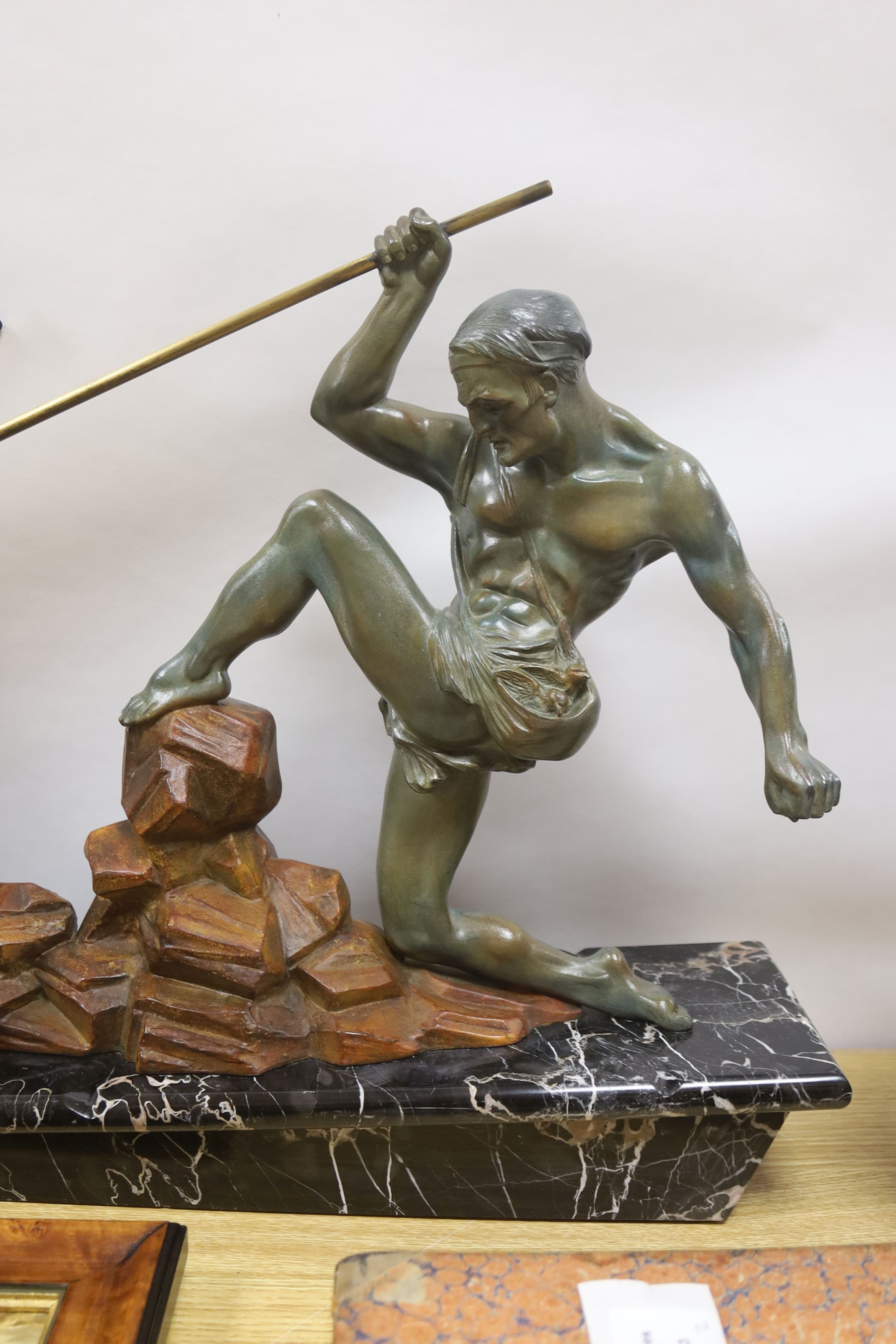 An Art Deco patinated spelter model of a hunter and eagle on a marble base - 77cm